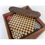 TWO ANTIQUE GAMES BOARDS, comprising an 18th Century carved cribbage board with floral carved