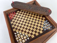 TWO ANTIQUE GAMES BOARDS, comprising an 18th Century carved cribbage board with floral carved