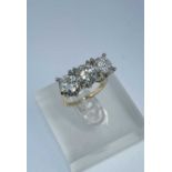 YELLOW & WHITE GOLD THREE STONE DIAMOND RING, the three round brilliant cut stones measuring 3.