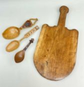 FOUR ITEMS OF TREEN comprising an oat-cake slice or riddleboard, 43cms, a sycamore wood treen