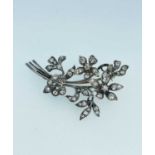 WHITE METAL DIAMOND ENCRUSTED BROOCH of floral spray design, overall set with diamonds of various
