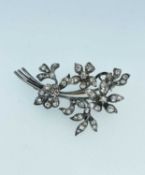 WHITE METAL DIAMOND ENCRUSTED BROOCH of floral spray design, overall set with diamonds of various