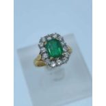 18CT GOLD EMERALD & DIAMOND CLUSTER RING, the central emerald (1.60ct approx.) surrounded by