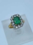 18CT GOLD EMERALD & DIAMOND CLUSTER RING, the central emerald (1.60ct approx.) surrounded by