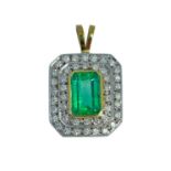 EMERALD & DIAMOND DOUBLE HALO PENDANT, yellow and white metal, the central emerald measuring 3.60cts