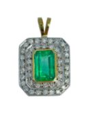 EMERALD & DIAMOND DOUBLE HALO PENDANT, yellow and white metal, the central emerald measuring 3.60cts