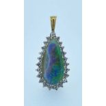 YELLOW & WHITE METAL OPAL & DIAMOND CLUSTER PENDANT, the central pear shaped opal (22 x 10mms)