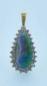 YELLOW & WHITE METAL OPAL & DIAMOND CLUSTER PENDANT, the central pear shaped opal (22 x 10mms)