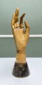 CARVED & JOINTED FRUITWOOD HAND MANNEQUIN, on tapering circular base, 30cms hProvenance:'The St John