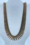 YELLOW GOLD FRINGE NECKLACE, of graduated tubular design, 40cms long, 31.5cms Provenance: private