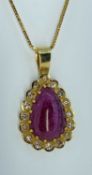 18K GOLD RUBY & DIAMOND PENDANT, the central cabochon pear shape ruby surrounded by sixteen