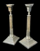 PAIR OF GEORGE V SILVER CANDLESTICKS, Maker NS, Birmingham 1929, of classical column design raised