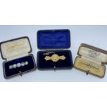 THREE VARIOUS BOXED BAR BROOCHES comprising 9ct gold sapphire and seed pearl brooch in Butt & Co