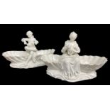 PAIR DRESDEN FIGURAL SWEETMEAT DISHES, a figure seated between clamshells on shsaped base, male