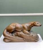 RICHARD FISHER, bronzed resin - Otter on a rock, signed, 14 x 26cms