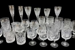 SUITE OF VARIOUS PATTERNED CUT GLASS DRINKING VESSELS, including tumblers, brandy glasses, wine