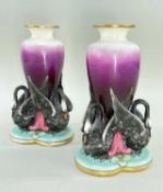 RARE PAIR OF WORCESTER PORCELAIN SWAN VASES, the graduated puce ovoid vessels supported by three