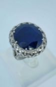 18CT WHITE GOLD LARGE SAPPHIRE & DIAMOND CHIP RING, the central claw set sapphire (20 x 17mms) above