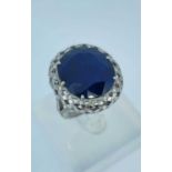 18CT WHITE GOLD LARGE SAPPHIRE & DIAMOND CHIP RING, the central claw set sapphire (20 x 17mms) above