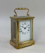 FRENCH BRASS CARRIAGE CLOCK, the white enamel face with Roman numerals, with winder Provenance:
