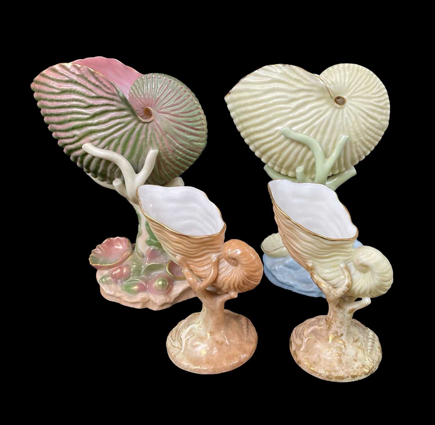 FOUR ROYAL WORCESTER NAUTILUS SHELL VASES, the two larger examples (17cms high) in unusual