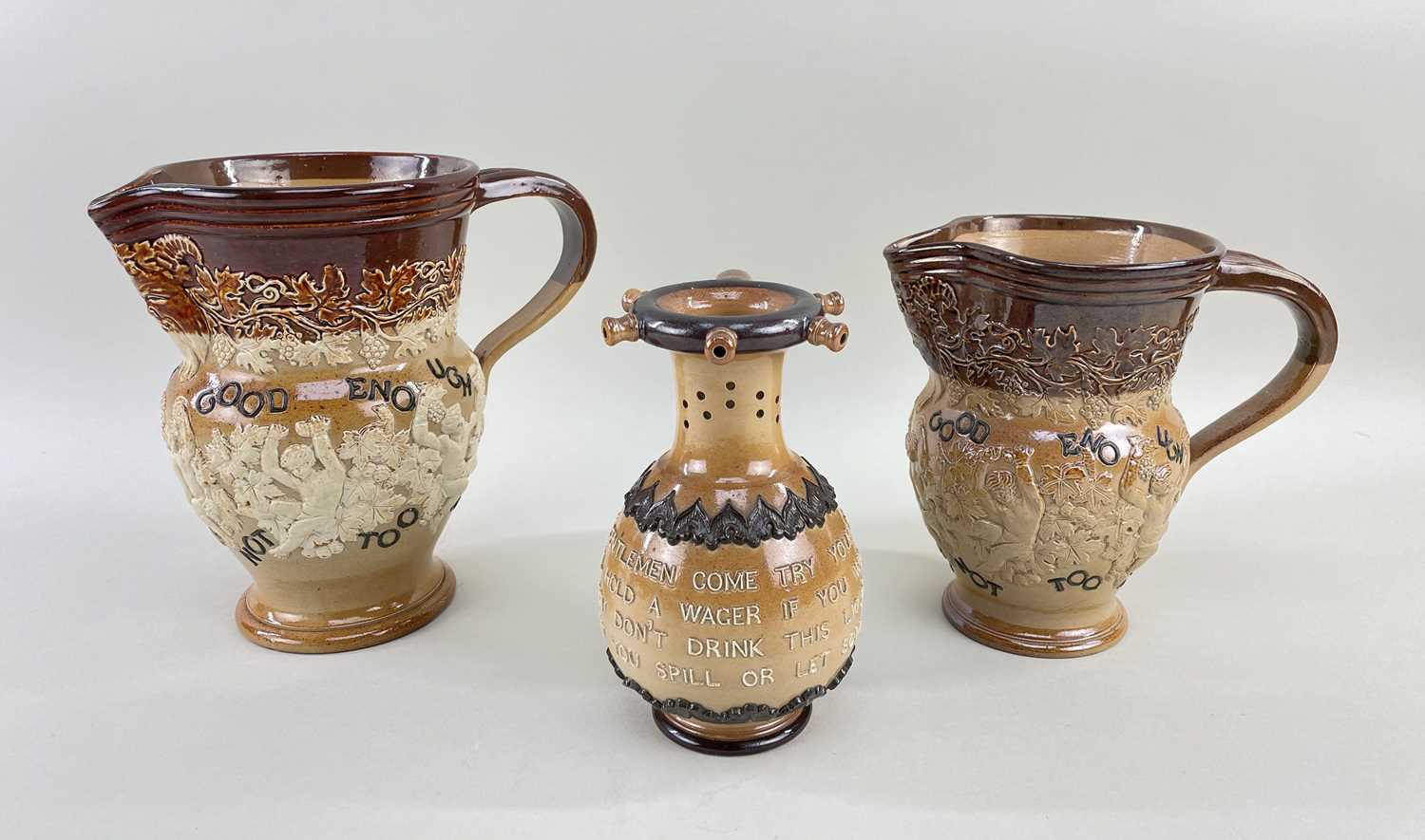 GROUP OF DOULTON LAMBETH comprising stoneware pitcher decorated with putti and vine leaves and motto