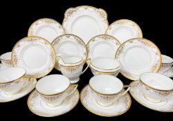 VINTAGE MINTON TEA SERVICE, decorated with gilt relief, swags and tails and solid gilt border,
