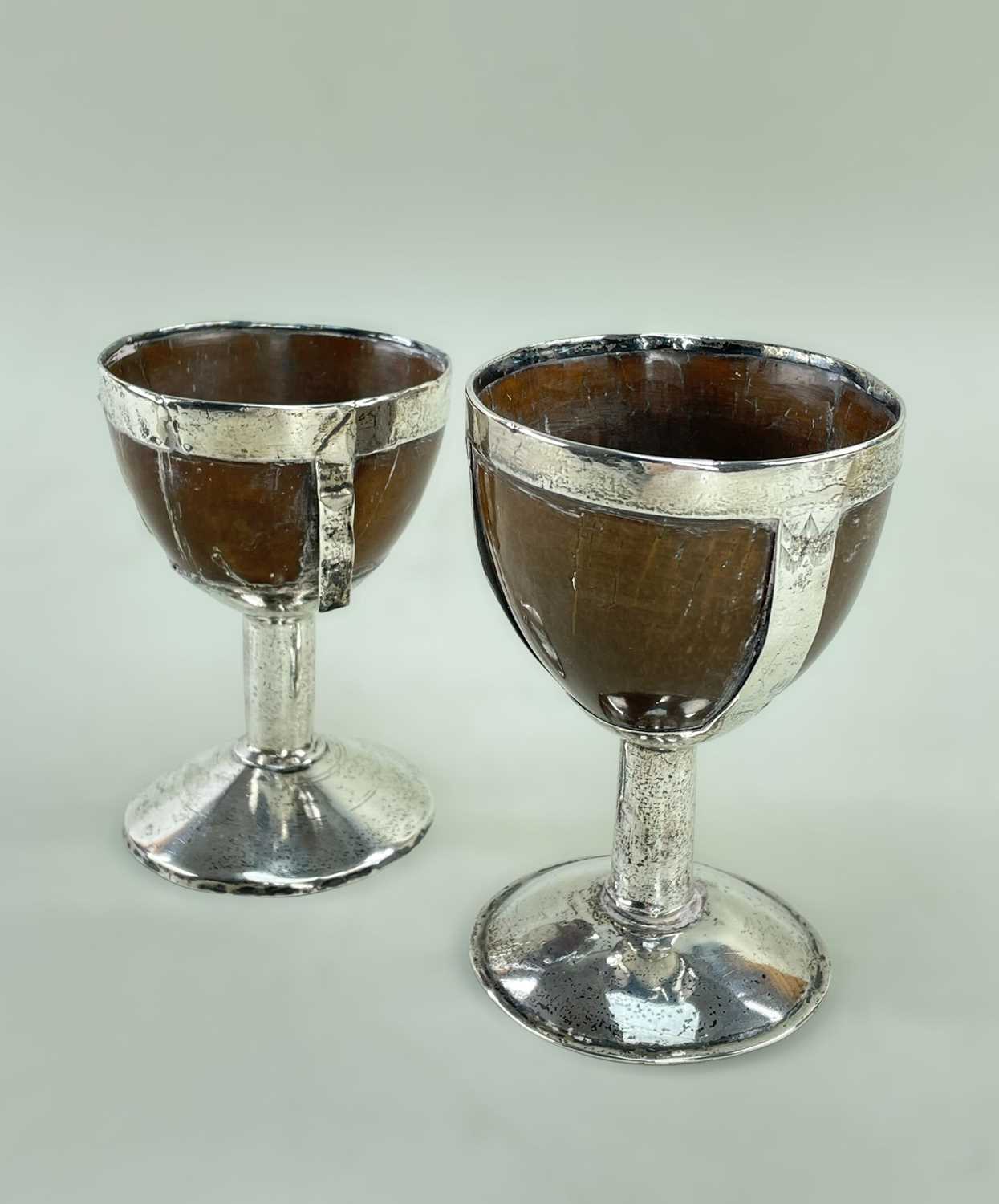 TWO SILVER MOUNTED COCONUT GOBLETS, c. 1800, one with feather engraved decoration, tallest 12cm h (