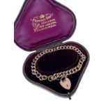 9CT GOLD CURB LINK BRACELET, having heart shaped padlock, 12.1gms, in fitted Prinsky Bros