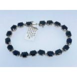 10K WHITE GOLD SAPPHIRE BRACELET, set with nineteen oval cut sapphires, 20cms long, 12.9gms