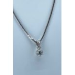 18K DIAMOND PENDANT on white gold box link chain stamped '750', the single diamond measuring 0.25cts