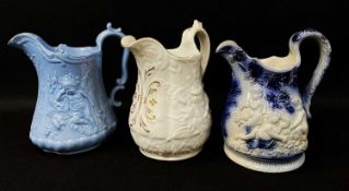 THREE GOOD YNYSMEUDWY MOULDED POTTERY JUGS comprising white glazed example with gilt scrolls to