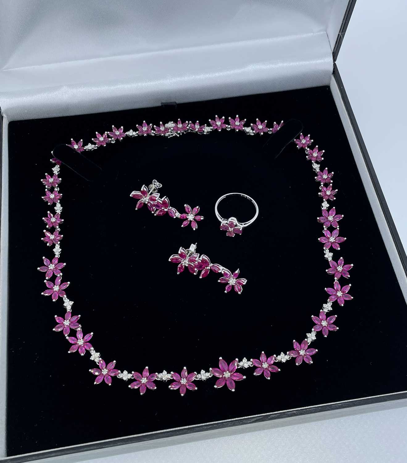 GOLD RUBY & DIAMOND JEWELLERY comprising 18K white gold ruby and diamond flower necklace, 43cms