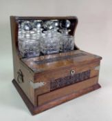 20TH CENTURY THREE-BOTTLE OAK TANTALUS BOX, 35.5cms wideComments: chips/cracks to 2/3 decanters,