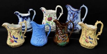 GROUP OF WELSH POTTERY MEDIUM SIZED MOULDED JUGS including Ynysmeudwy 'Triple Cherub', copper-