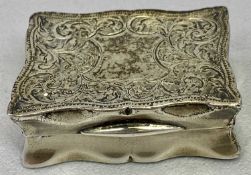 EDWARDIAN RECTANGULAR SILVER SNUFF BOX with serpentine outline, the cover engraved with scrolls
