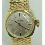 OMEGA 9CT GOLD LADY'S BRACELET WRISTWATCH - circular dial set with baton markers, the movement