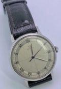 VINTAGE OMEGA GENT'S STAINLESS STEEL WRISTWATCH - with black leather strap, having a quartered and