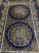 AN EASTERN RUG - blue ground with central twin sunburst type pattern, 2.3m x 1.45m