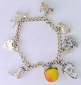 SILVER CHARM BRACELET - with several charms including a non-silver fruit charm, 1.045ozt gross