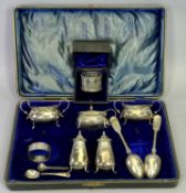 GEORGE V SILVER FIVE PIECE CONDIMENT SET, in fitted case, silver napkin ring in case, another silver