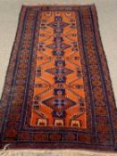 EASTERN RUG - blue and red ground with repeating diamond/zig zag central pattern and multi