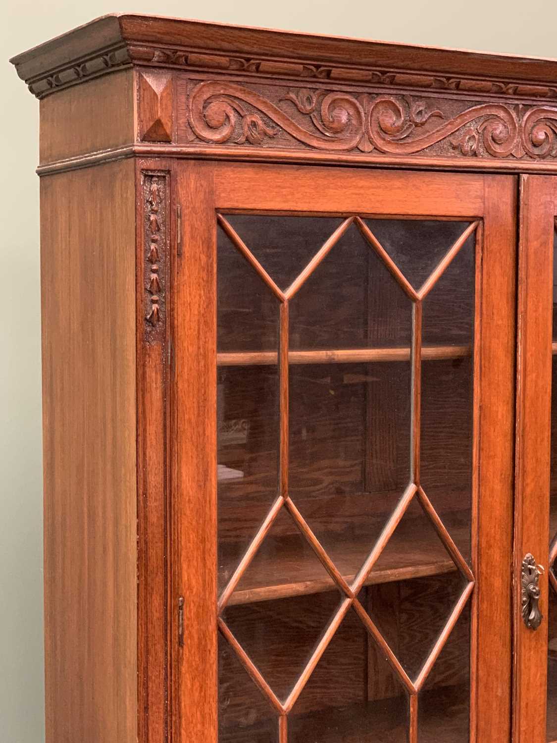 AN OAK EDWARDIAN BOOKCASE CUPBOARD - with carved detail, astragal type glazed twin doors, two - Image 3 of 4