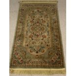 ORNATE WOOLLEN RUG - multi-coloured floral pattern and tasselled ends, 81 x 145cms