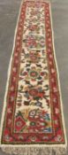 VINTAGE WOOLLEN RUGS - in two similar colourful floral patterns, a runner 334 x 71cms and rug 181
