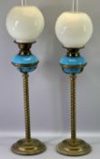 OIL LAMPS - pair of late 19th century oil lamps, tall circular brass twist stem columns,