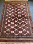 RUGS - red and cream background with central repeat pattern and multi-bordered edge, 195 x 125cms