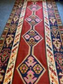 RUGS - Red Aztec design with central diamond pattern, multi-bordered edge and tasselled ends, 390