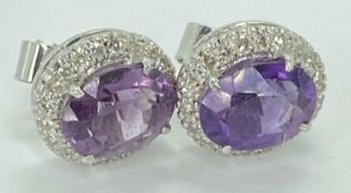 AMETHYST & DIAMOND CLUSTER EARRINGS, A PAIR - unmarked white metal in a Boodle & Dunthorne box,