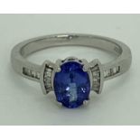 PLATINUM DIAMOND & TANZANITE RHAPSODY RING - 7 x 5mm central stone flanked to the shoulders by